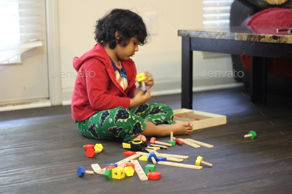 Kid busy making creative blocks game and creating new designs