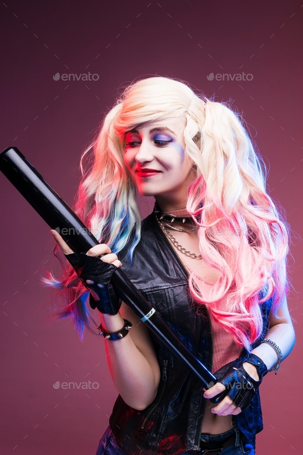 Cosplayer girl with a baseball bat in a Harley Quinn costume. Stock