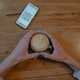 top view of phone with kuar code and hands holding a cup of coffee in a cafe - PhotoDune Item for Sale