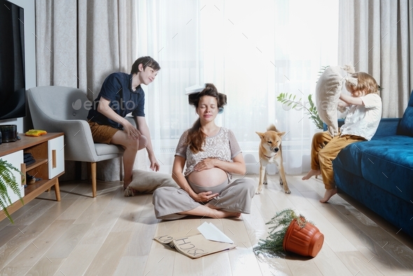 calm pregnant mother meditating in the middle of family chaos. Psychology of education. Family fun