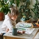 Cute boy painting at home, using online lesson on smartphone. Online education concept - PhotoDune Item for Sale