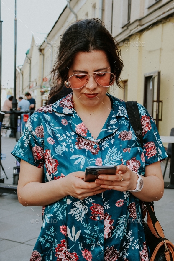 Girl in summer days using her phone  - Stock Photo - Images