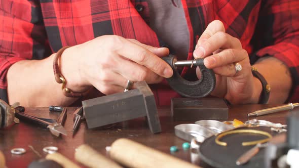 Young Man Concentrated on Cleaning Tool in Workshop alt