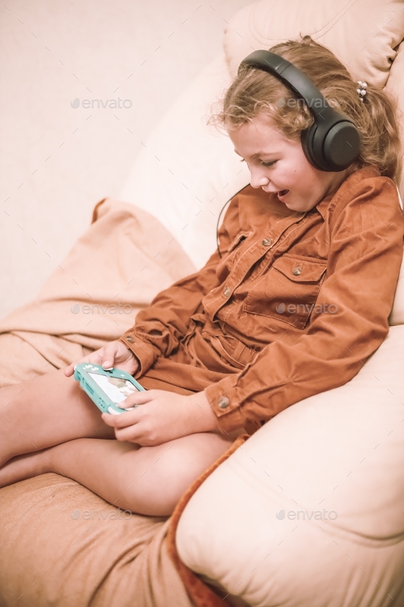 teenager girl playing games on a console at home. Console games  - Stock Photo - Images