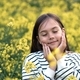 a preteen girl of ten years, a walk in nature, flowering fields of rapeseed, portrait, emotions - PhotoDune Item for Sale