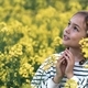 a preteen girl of ten years, a walk in nature, flowering fields of rapeseed, portrait, emotions - PhotoDune Item for Sale