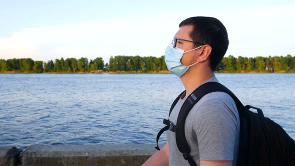 A Man In A Mask Walks Near The River