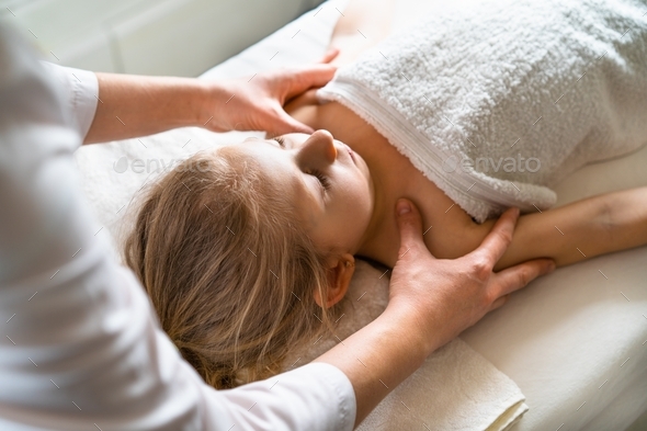 Little girl on massage, osteopathy, massage therapist\'s hands, child health, prevention