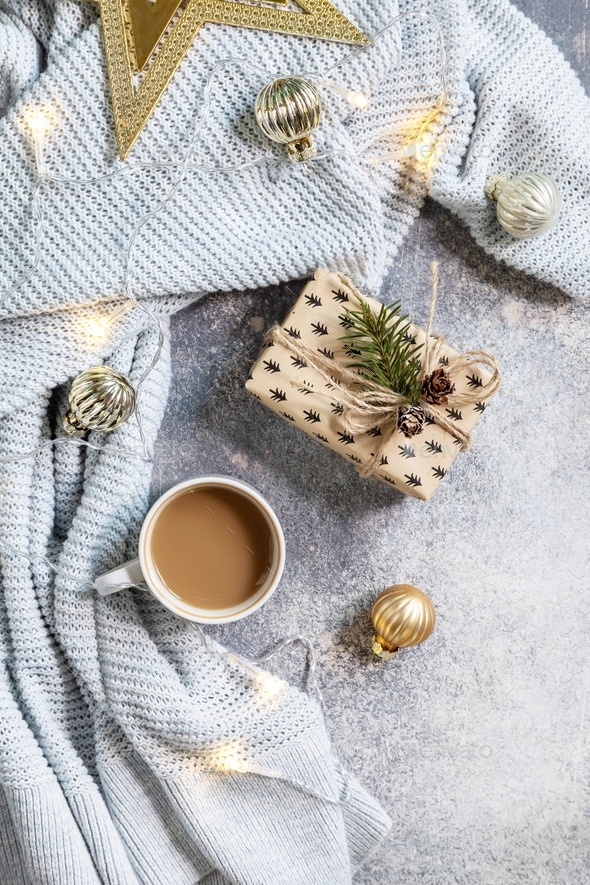 New Year\'s or Christmas composition. Cup of coffee, christmas star, knitted blanket, garland.