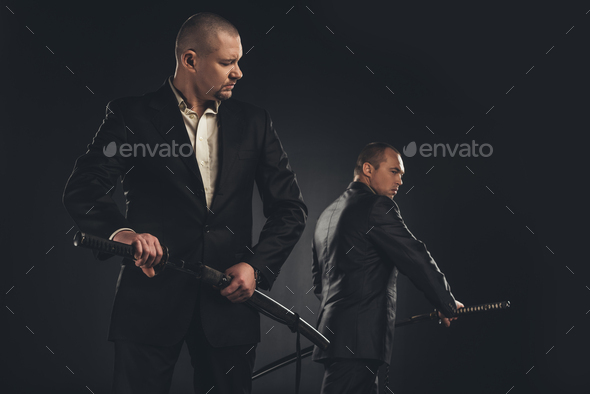 two handsome modern samurai with katanas isolated on black Stock Photo ...