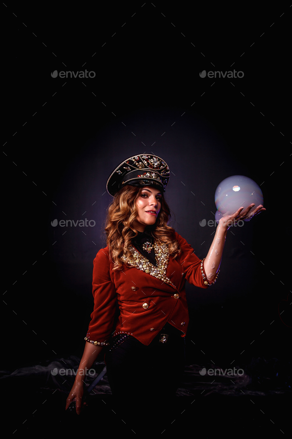 Woman magician illusionist circus with stylish hat in shows soap bubbles show at black background