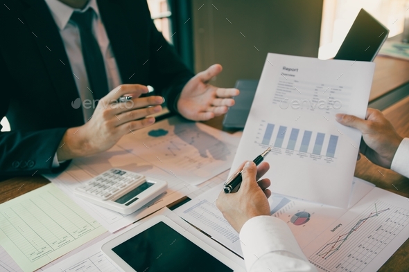 Group of business people analysis summary graph reports of business operating expenses and work data - Stock Photo - Images