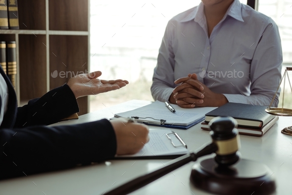 Lawyer is giving advice to clients who have consulted about legal issues regarding rights infringeme - Stock Photo - Images