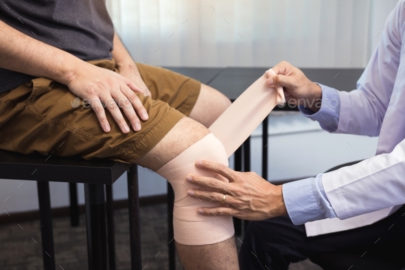 Asian physiotherapists are examining the results of knee surgery. - Stock Photo - Images