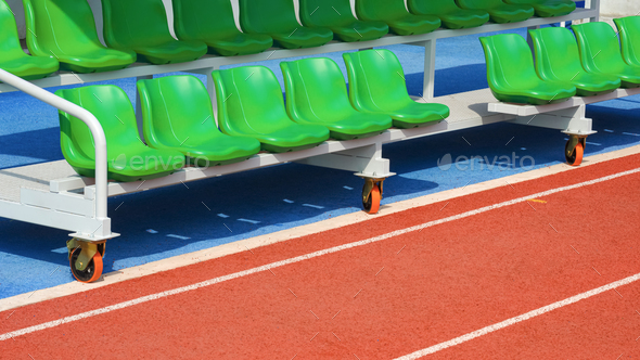 Reserve and coaching staff bench on rubber floor in outdoor sports stadium