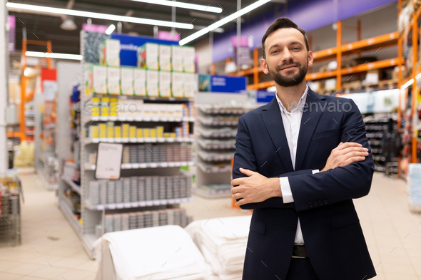 portrait of a successful hardware store owner in a business suit