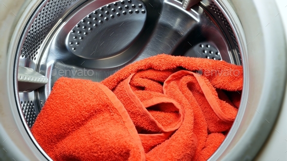 Washing drying machine with red towel in laundry