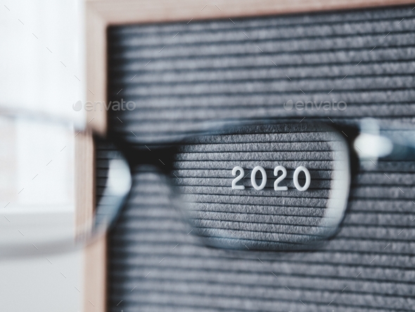 Letter board with numbers 2020 through eyeglasses. 2020 results. Social, politic issues.