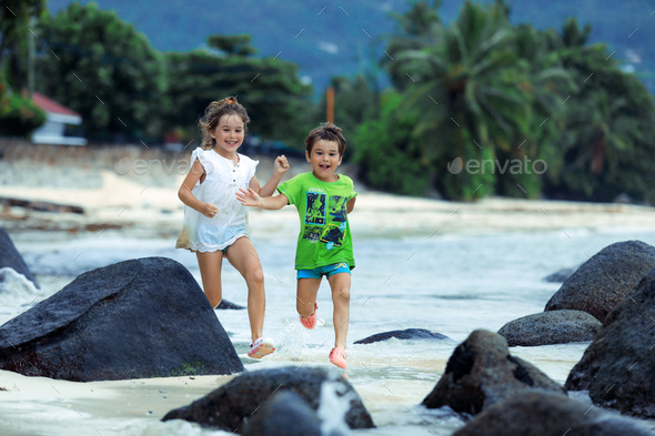 Children running on the beach  - Stock Photo - Images