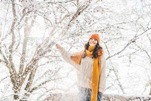 Portrait of smiling woman enjoying snow day. - Stock Photo - Images