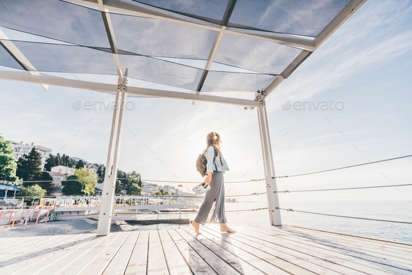 Woman walking near the sea. - Stock Photo - Images