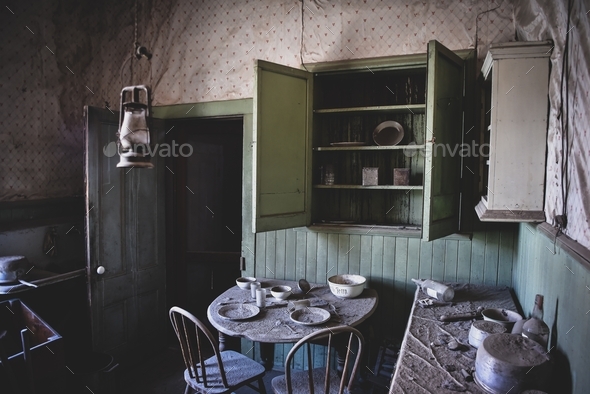 Abandoned dining room in an old house with table and chairs and dilapidated walls and ceiling - Stock Photo - Images