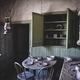 Abandoned dining room in an old house with table and chairs and dilapidated walls and ceiling - PhotoDune Item for Sale