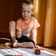 a little boy paints sitting on the floor of the room - PhotoDune Item for Sale