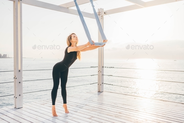 Woman doing yoga at the sea. - Stock Photo - Images