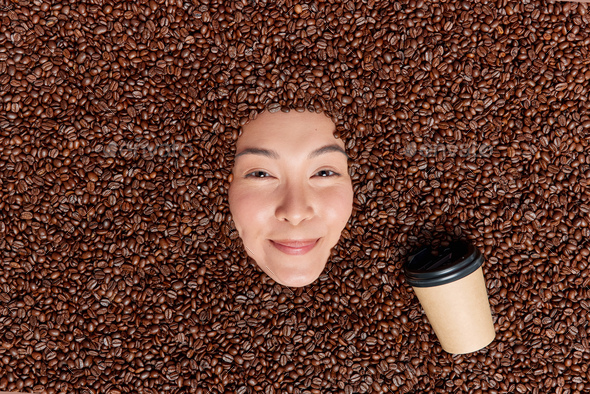 Positive sincere young Asian woman tests delicious coffee beans recipes at home prepares caffeine be