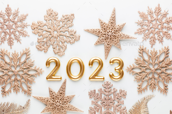 New year 2023 number, golden digits and santa hat over blue background. - Stock Photo - Images