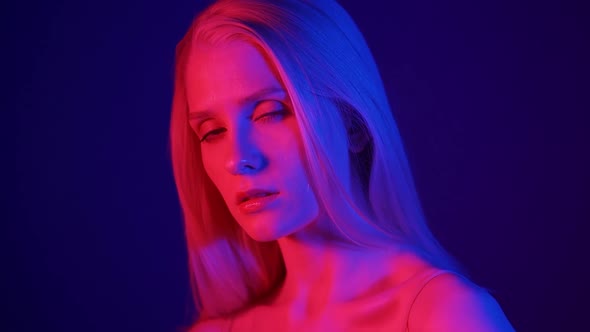 Portrait of a Stylish Blonde Model in Colored Lighting