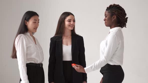 Three Diverse Women Talking on White Background alt