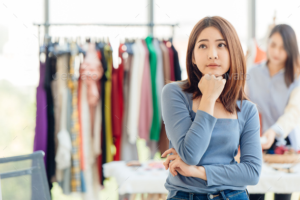 clothing shop owner thinking worry about financial problem business money income and profit