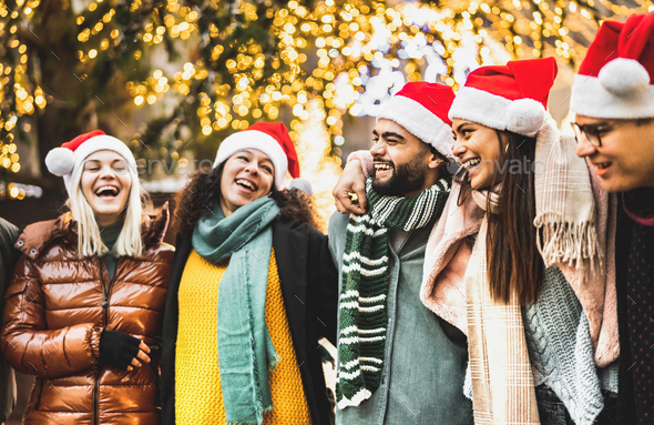 Trendy people group walking under Christmas tree decoration - Stock Photo - Images