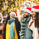 Trendy people group walking under Christmas tree decoration - PhotoDune Item for Sale