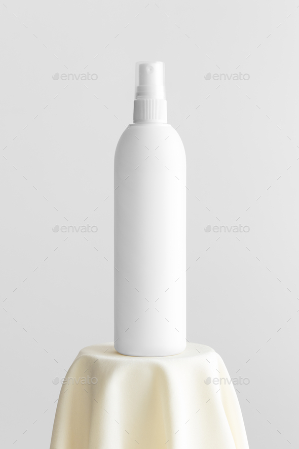 White cosmetic spray bottle mockup on the yellow textile.