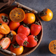 ripe persimmon orange fruit in a basket - PhotoDune Item for Sale