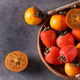 ripe persimmon orange fruit in a basket - PhotoDune Item for Sale