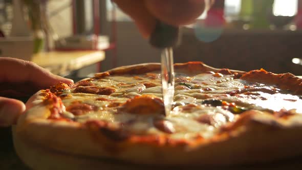 Slicing Up Pizza with Restaurant Bakery Knife