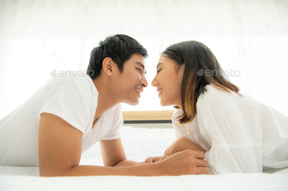 Couples are happy to relax in the white bedroom and share love with each other.