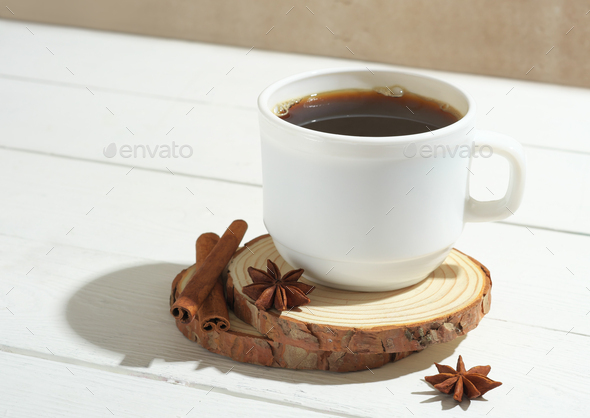 espresso coffee in white mug on wooden table with cinnamin sticks and anise stars. - Stock Photo - Images