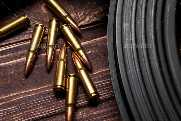 Bullets and Kalashnikov assault rifle on wooden background - Stock Photo - Images