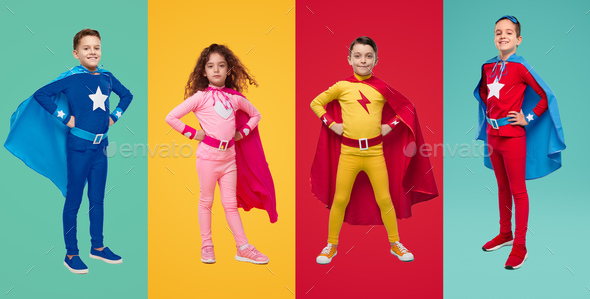 Courageous kids in superhero costumes in studio