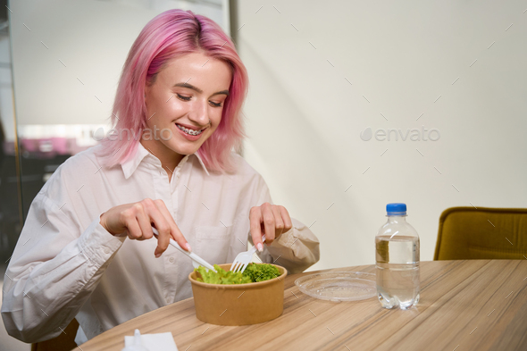 Pretty lady having lunch in the office - Stock Photo - Images