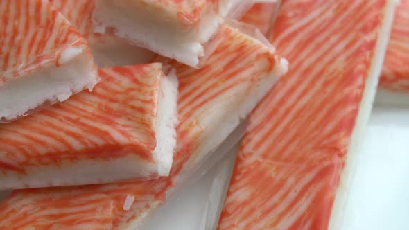 Crab Sticks Rotate on a Plate As Background Delicious and Juicy Crab Meat Rotates on a Plate Crab alt