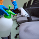 Hard-working cleaner using chemicals to disinfect the chairs - PhotoDune Item for Sale