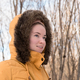 Woman in yellow parka with fur hood closeup portrait - PhotoDune Item for Sale