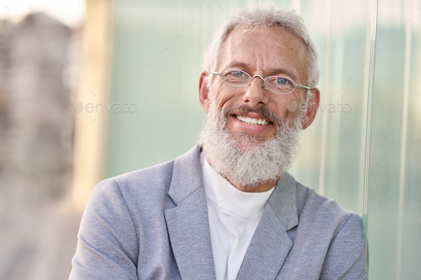 Smiling happy senior older business man standing outdoors, headshot portrait. - Stock Photo - Images