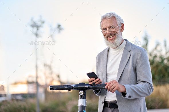 Happy old man using mobile app for bike rental renting bike in city park. - Stock Photo - Images